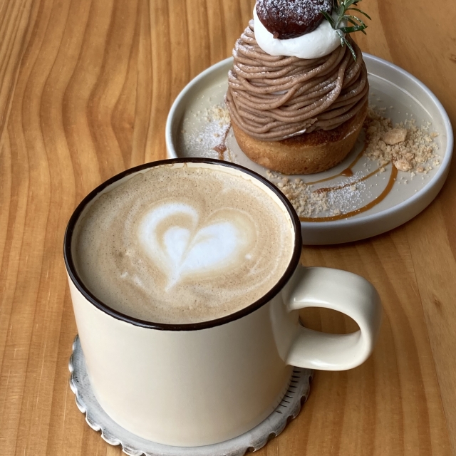 栗のモンブランケーキの横にハートのラテアートが描かれたカフェラテ
